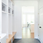 Painted white laundry/mud room with lockers.