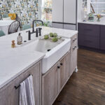 White and purple painted kitchen cabinets with stained hickory island cabinets.
