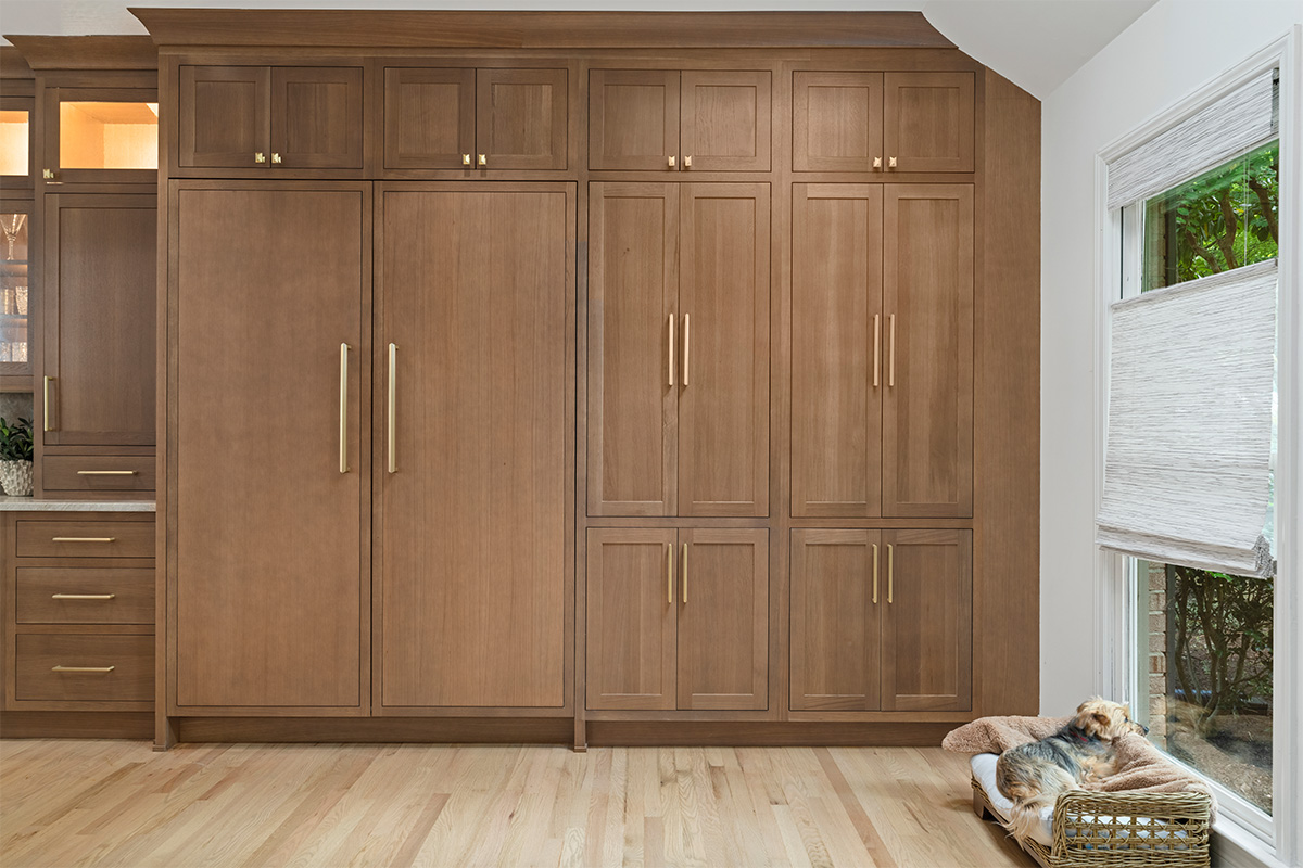 Stained white oak fridge panels covering large refrigerators.