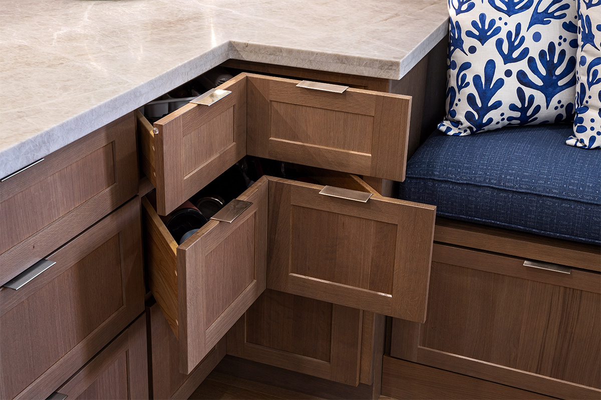Brown-stained corner drawer cabinet with drawers pulled out.