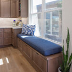 Brown-stained bench seating with blue cushion