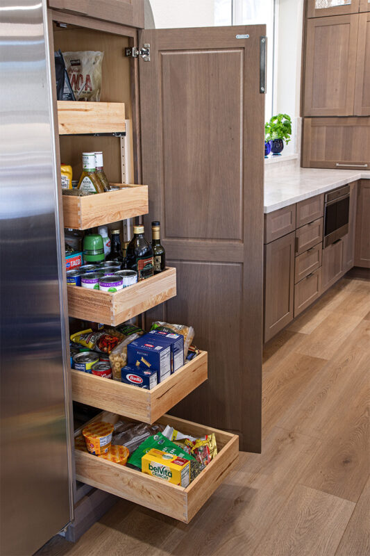 Tall cabinet with door open and 5 roll trays inside