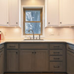 White uppers and gray stained lower kitchen cabinets