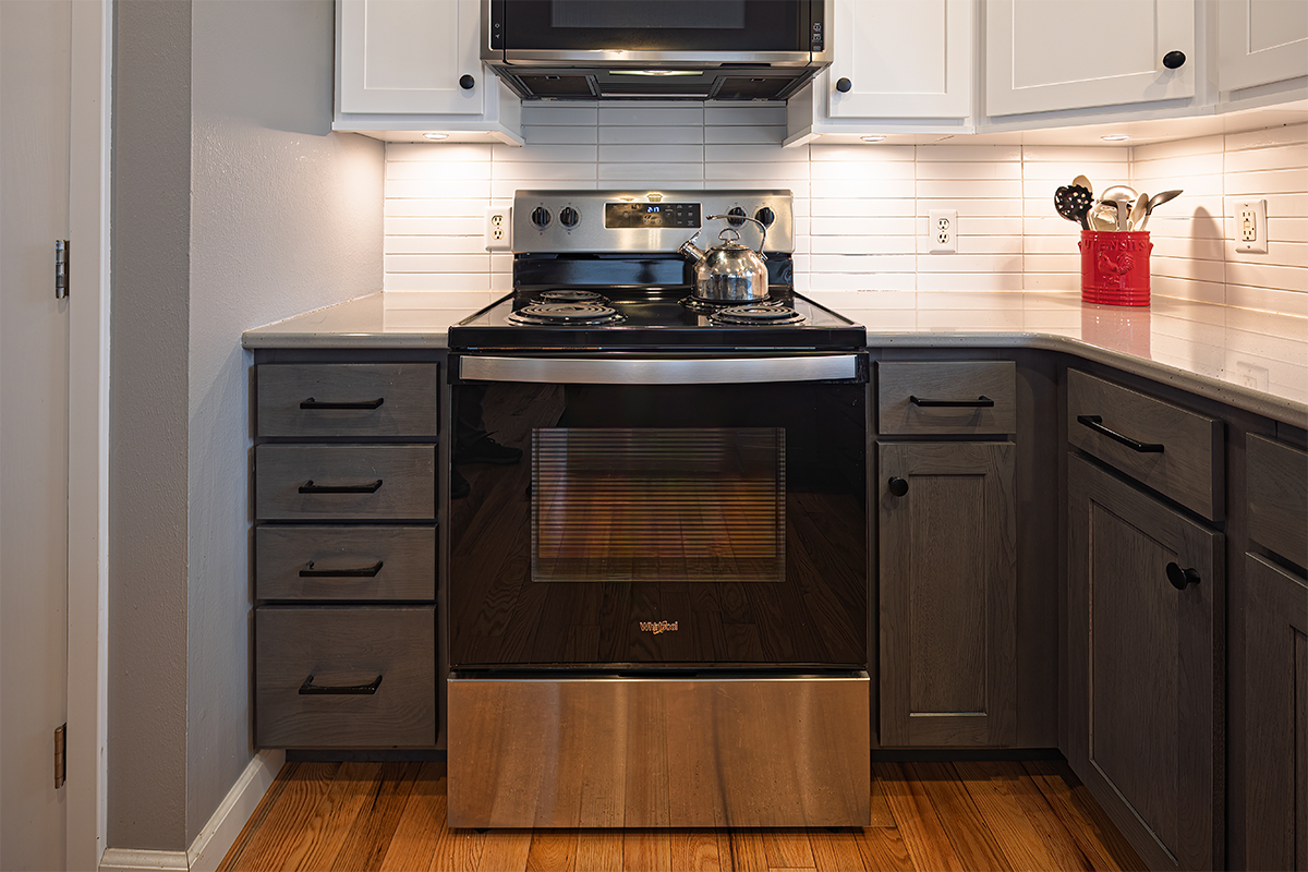 White uppers and gray stained lower kitchen cabinets