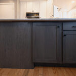 White uppers and gray stained lower kitchen cabinets
