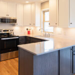 White uppers and gray stained lower kitchen cabinets