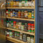 Blue kitchen cabinet with spice pullout