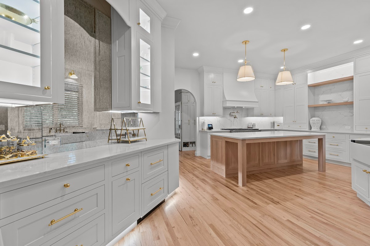 White kitchen perimeter cabinets with an island in washed out light brown Vita stain on Rift White Oak.