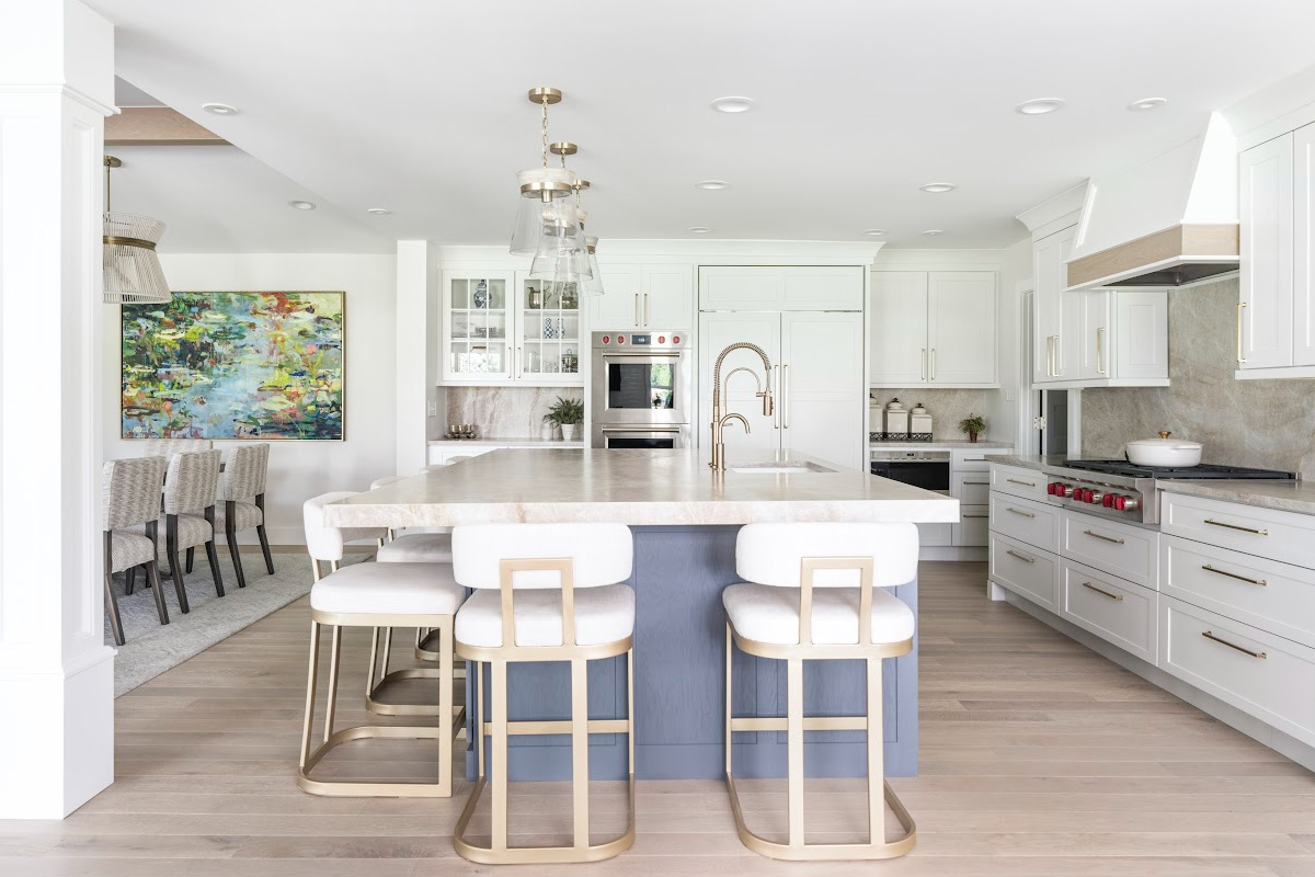 Kitchen with white perimeter and blue island cabinets.