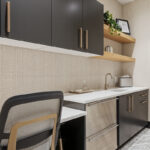 Gray painted office cabinets and desk with small kitchenette.