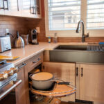 Quartersawn White Oak kitchen in a light Pampas finish showing a pulled out magic susan kit.