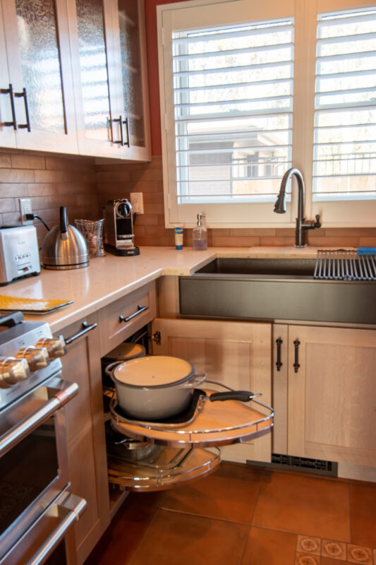 Quartersawn White Oak kitchen in a light Pampas finish showing a pulled out magic susan kit.