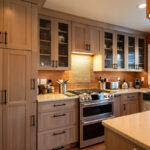 Quartersawn White Oak kitchen in a light Pampas finish with small island and stainless steel appliances.