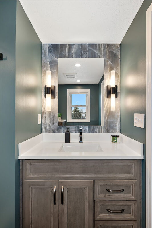 Brown stained bathroom vanity next to a glass steam shower.
