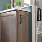 Brown stained bathroom vanity next to a glass steam shower.