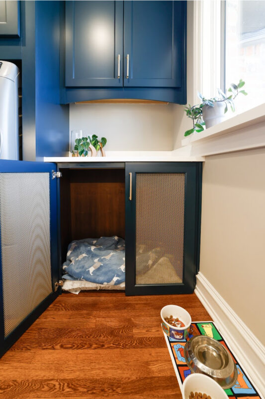 Emerald blue laundry with dog crate cabinet.