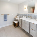 Large master bathroom with 2 vanity areas with light Montana stain, powder desk.