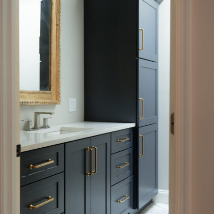 Dark Blue bathroom vanity and linen cabinets.