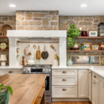 Old World style kitchen with Light Mocha-painted perimeter and a custom wood island in a mid-brown stain.