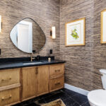 Bathroom with warm, organic tones, including a brown-stained vanity cabinet.