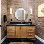 Bathroom with warm, organic tones, including a brown-stained vanity cabinet.