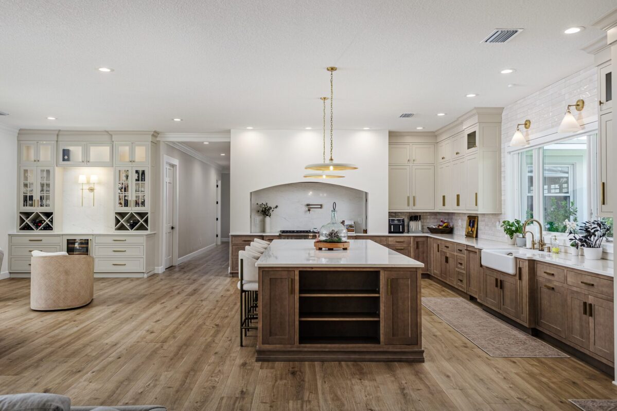 Light brown-stained lower and kitchen cabinets with gray painted uppers.