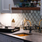 Painted gray kitchen cabinets with black range