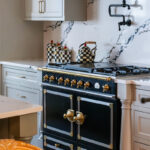 Painted gray kitchen cabinets with black range