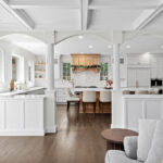 View into a partially closed off kitchen with white and natural rift white oak cabinets.