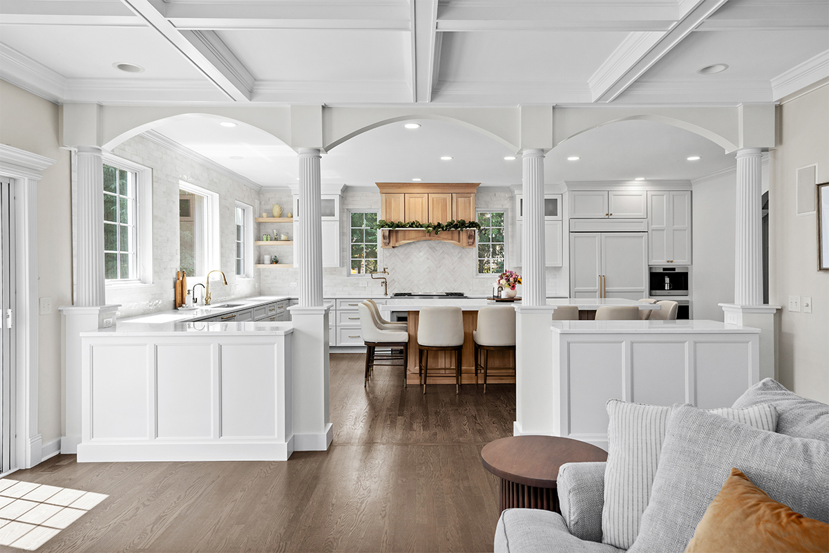 View into a partially closed off kitchen with white and natural rift white oak cabinets.