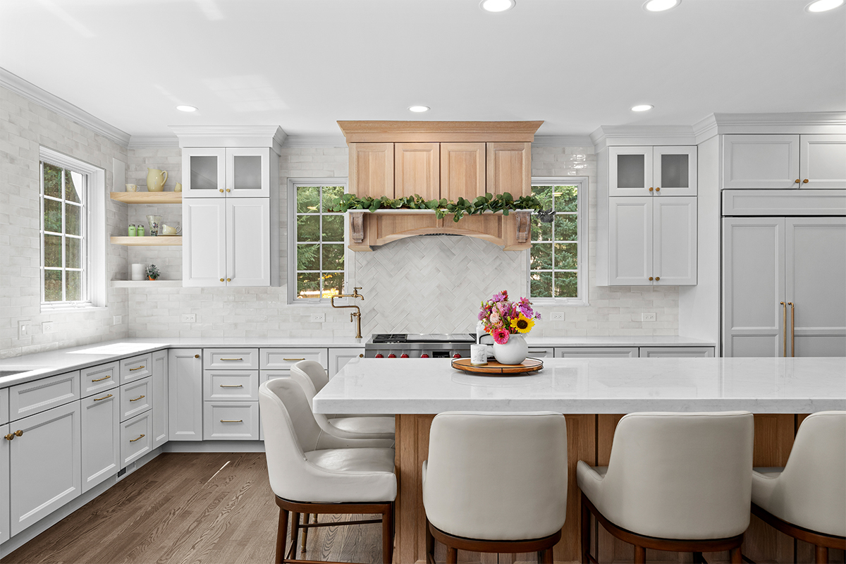kitchen with white perimeter and stained rift white oak island cabinets.
