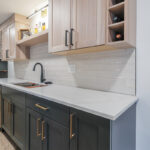 Contemporary kitchen with cabinets in light stain and blue paint.