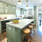 Light green painted kitchen with island.