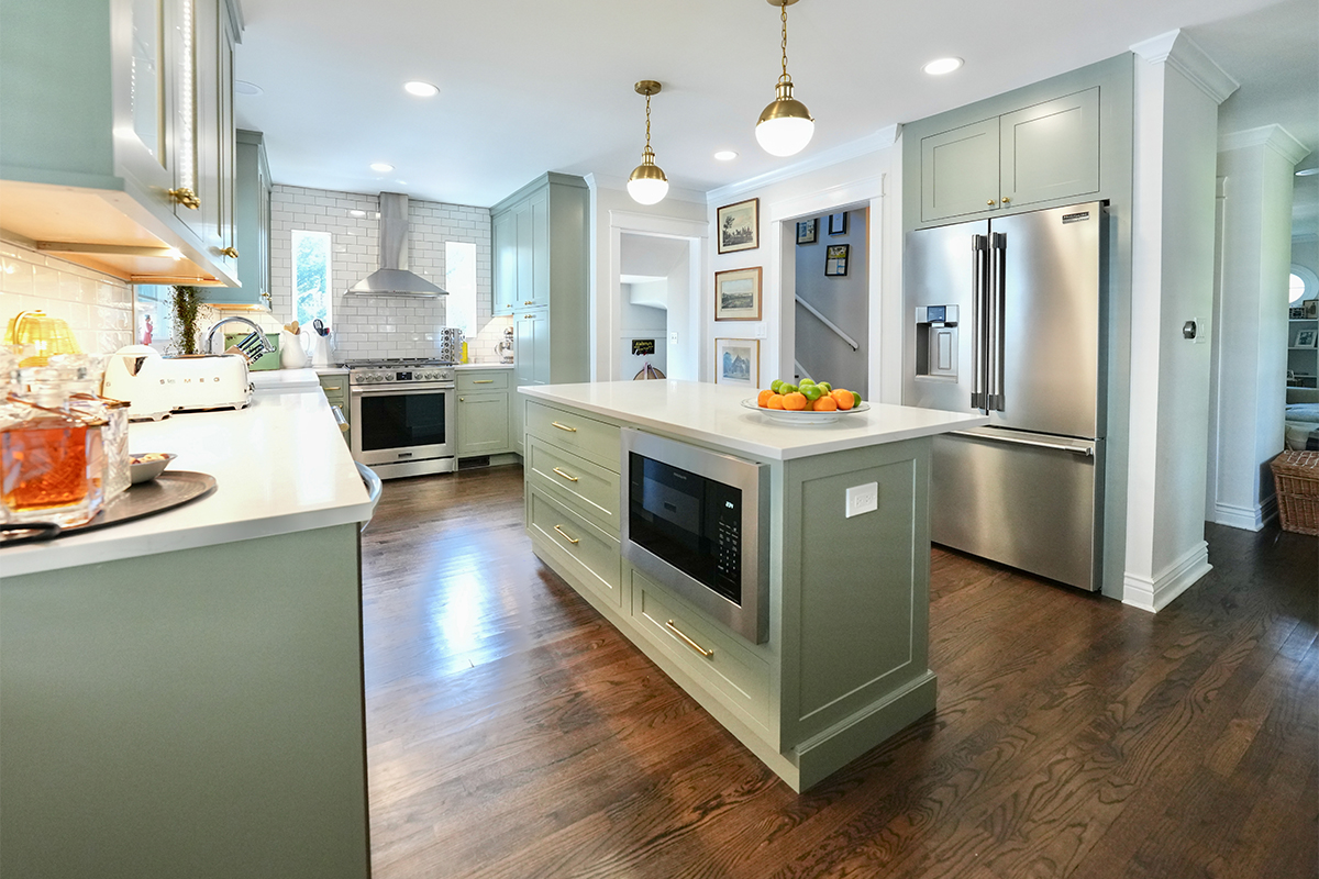 Light green painted kitchen with island.