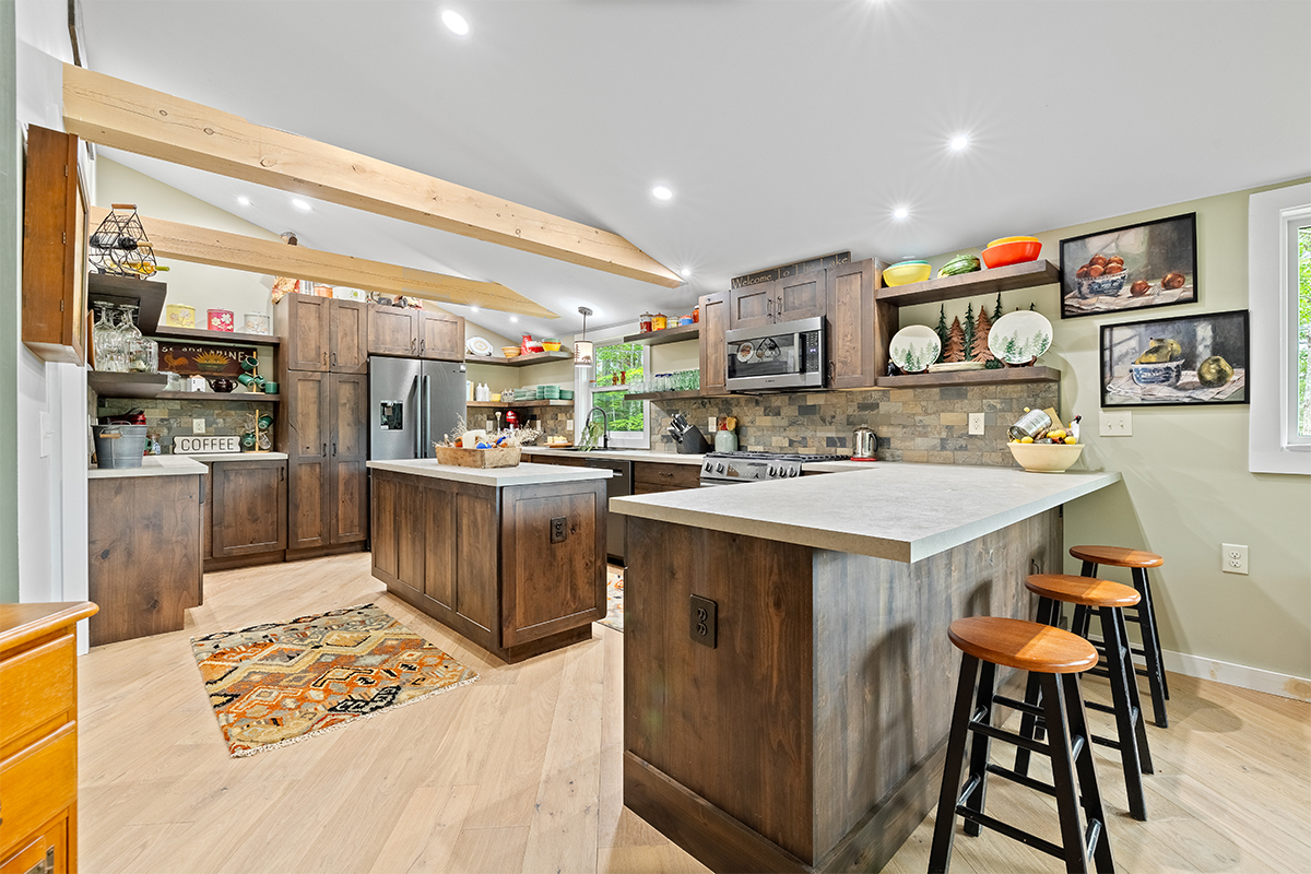 Rustic Alder kitchen with ceiling beams and floating shelves.