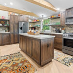 Rustic Alder kitchen with ceiling beams and floating shelves.