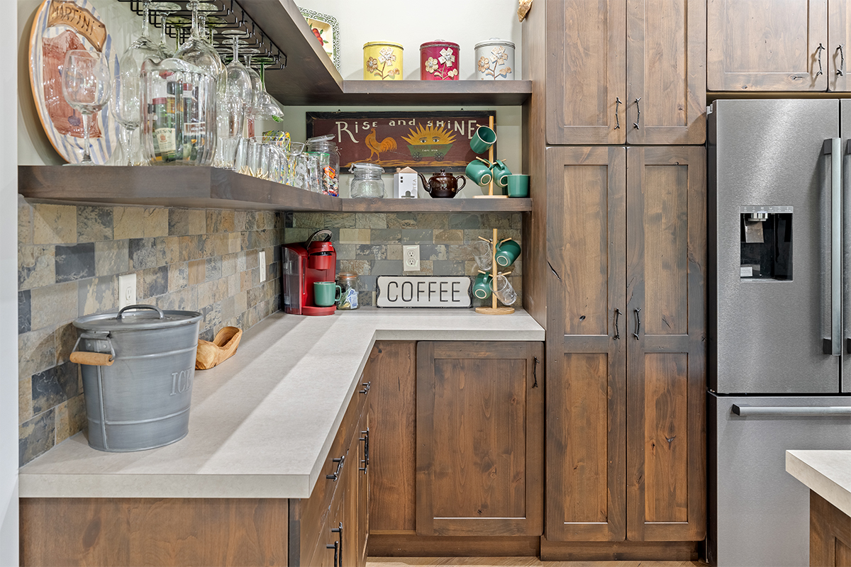 Rustic Alder kitchen with ceiling beams and floating shelves.