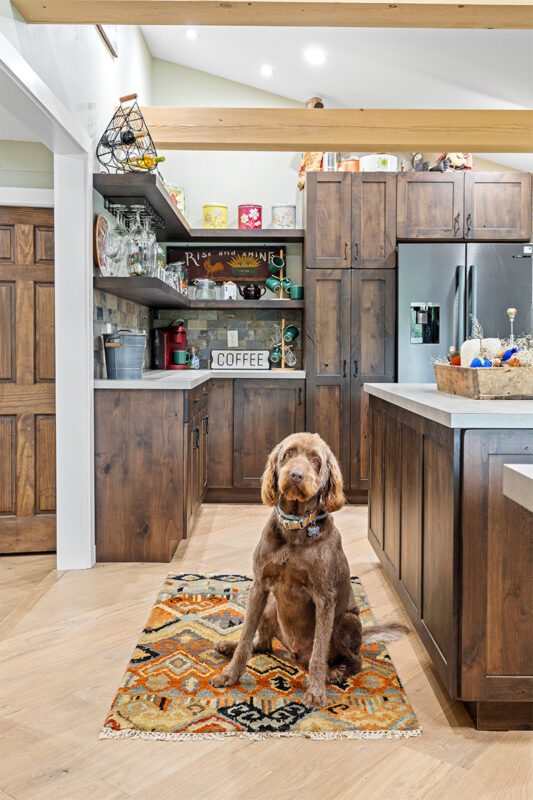 Rustic Alder kitchen with ceiling beams and floating shelves.
