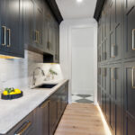 Kitchen with dark Iron Ore painted cabinets.