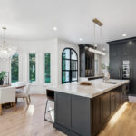 Kitchen with dark Iron Ore painted cabinets and a white hood. Includes a long island with seating.