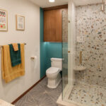 Bathroom with a stained wall cabinet above the toilet.