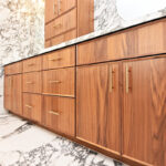 Walnut bathroom cabinets in Natural with walls and floors made of marble.