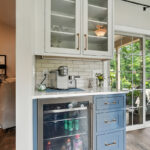 White and blue bar cabinets with wine cooler fridge.