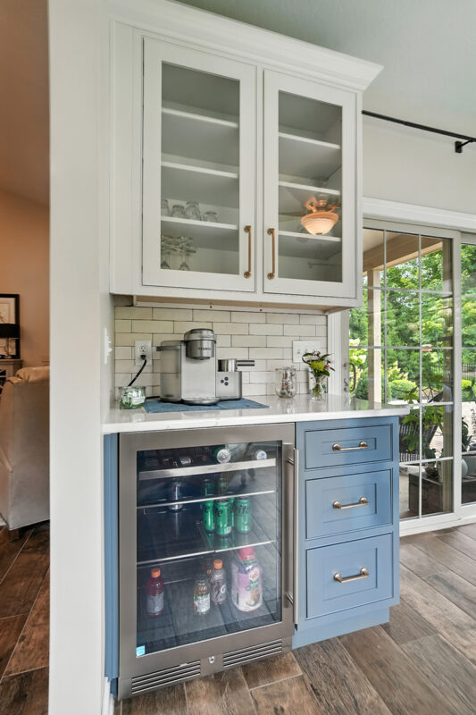 White and blue bar cabinets with wine cooler fridge.
