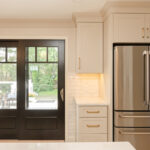 Light Mocha painted perimeter kitchen cabinets and an island with dark stained accent.