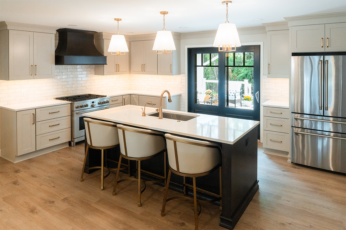 Light Mocha painted perimeter kitchen cabinets and an island with dark stained hood and island.