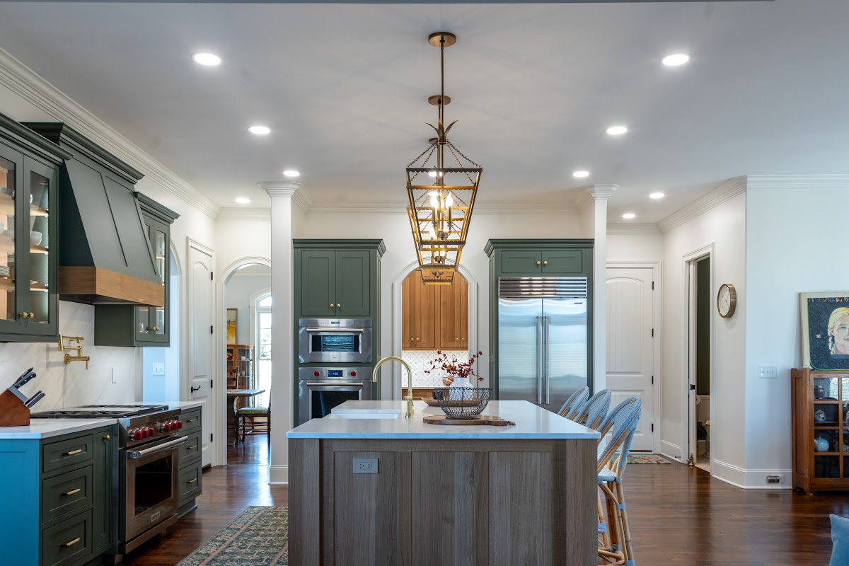 Green and white oak kitchen cabinets and island.