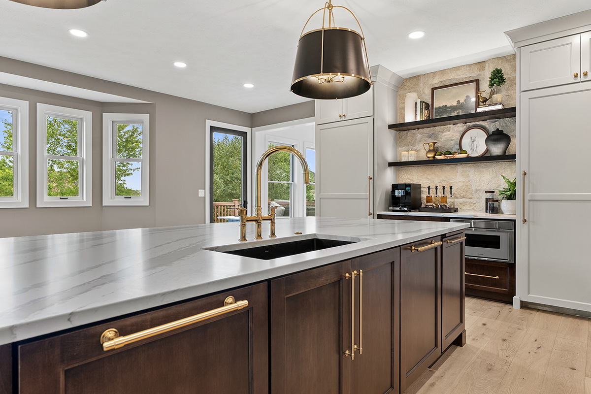 White and dark stained kitchen cabinets with white counter.