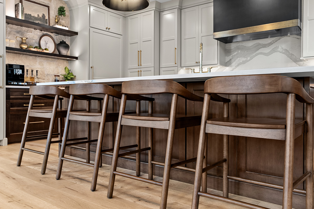 White and dark stained kitchen cabinets with white counter.