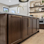 White and dark stained kitchen cabinets with white counter.